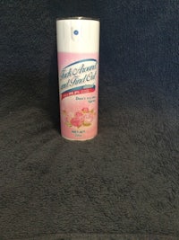 a tube of baby powder sitting on a blue blanket