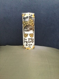a can of soda sitting on top of a bed