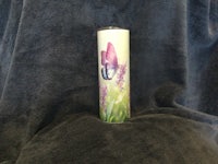 a tin can with a butterfly on it