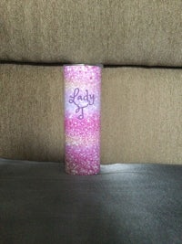 a pink and purple cup sitting on a couch